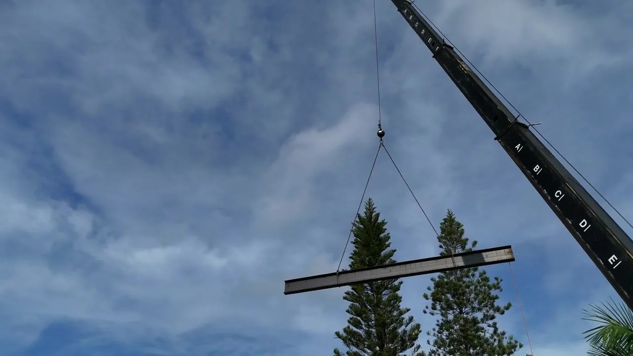 A steel beam being moved at an On Time Welding worksite